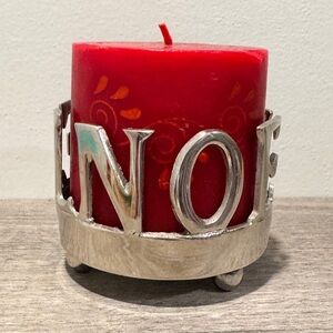 silver-plated "NOEL" candle holder with a red pillar candle